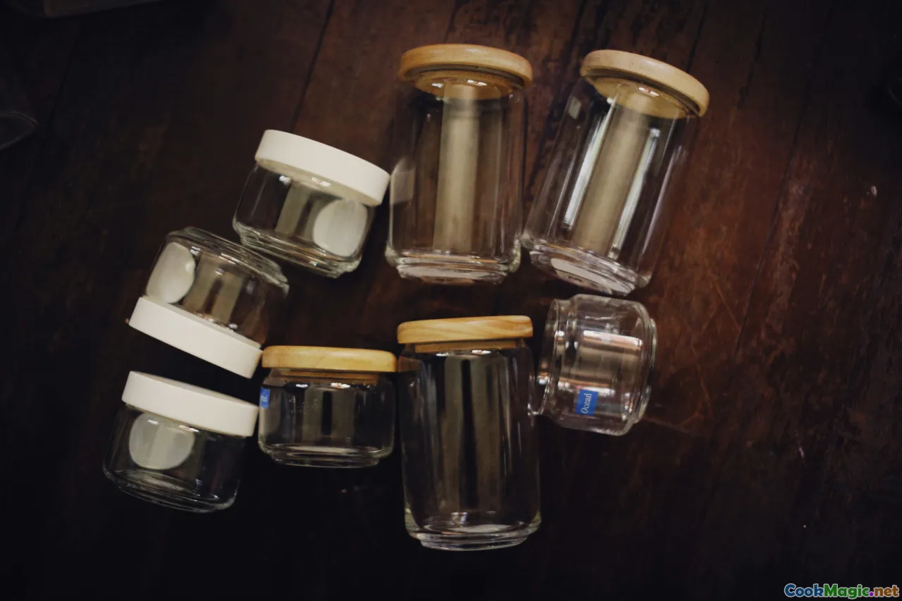 glass jars, spice grinder, hand mortar, labeled shelves