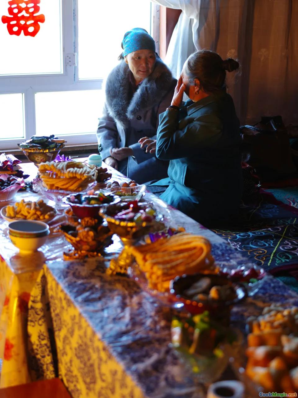 Kyrgyz family meal, traditional feast, shared dishes, mountain landscape, cultural celebration
