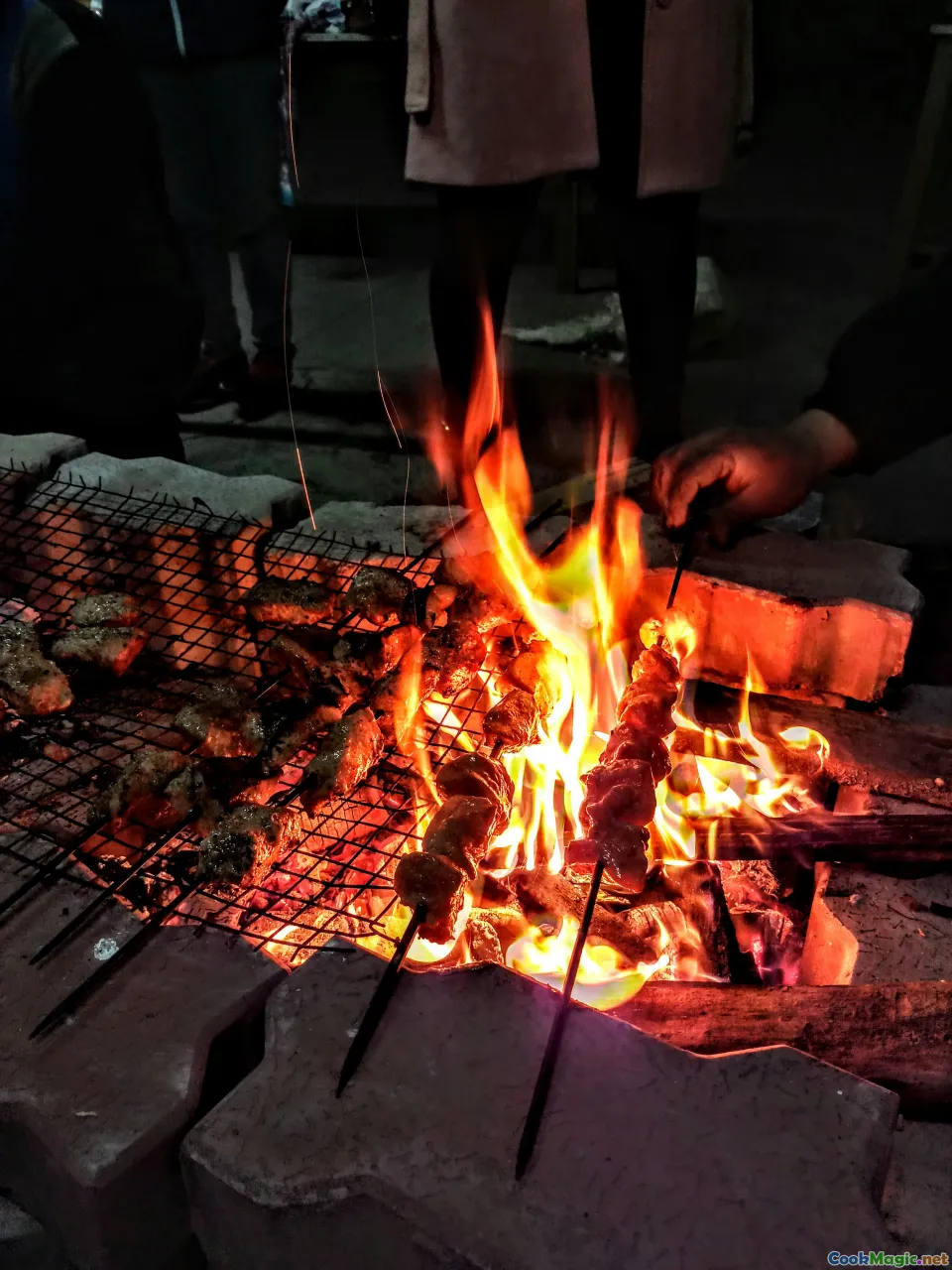 skewering, grilling techniques, meat cubes, street food cart